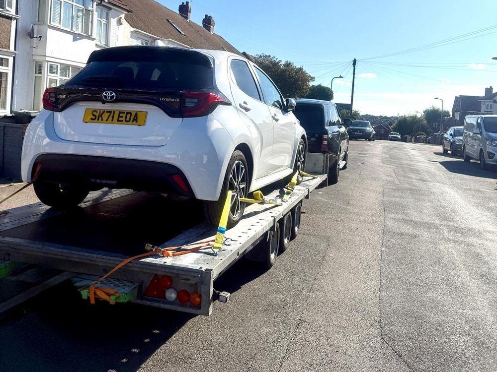 White Toyota Yaris secured on a car trailer